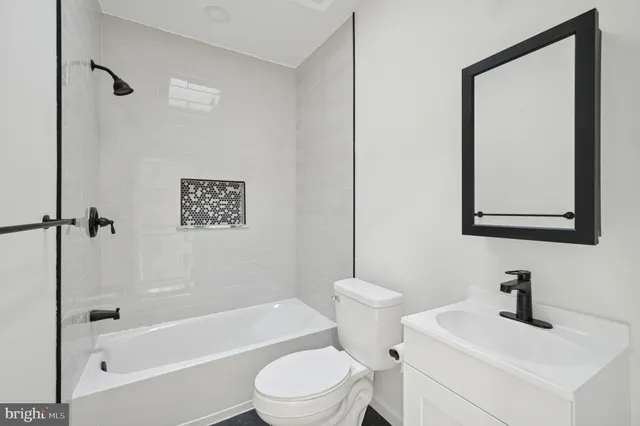 a white toilet sitting next to a bath tub