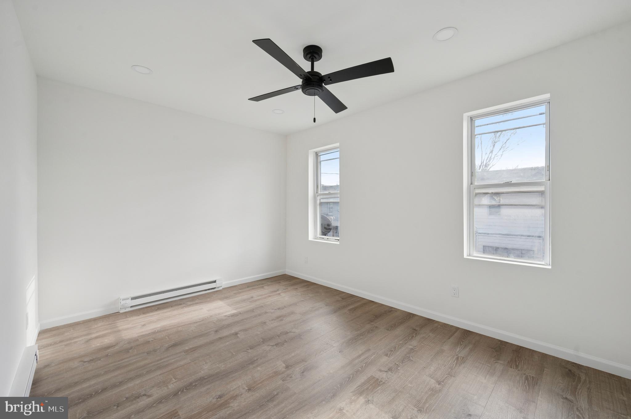5929 Spring Street Philadelphia, PA 19139 - Photo 14 of 15 a view of room with ceiling fan and wooden floor