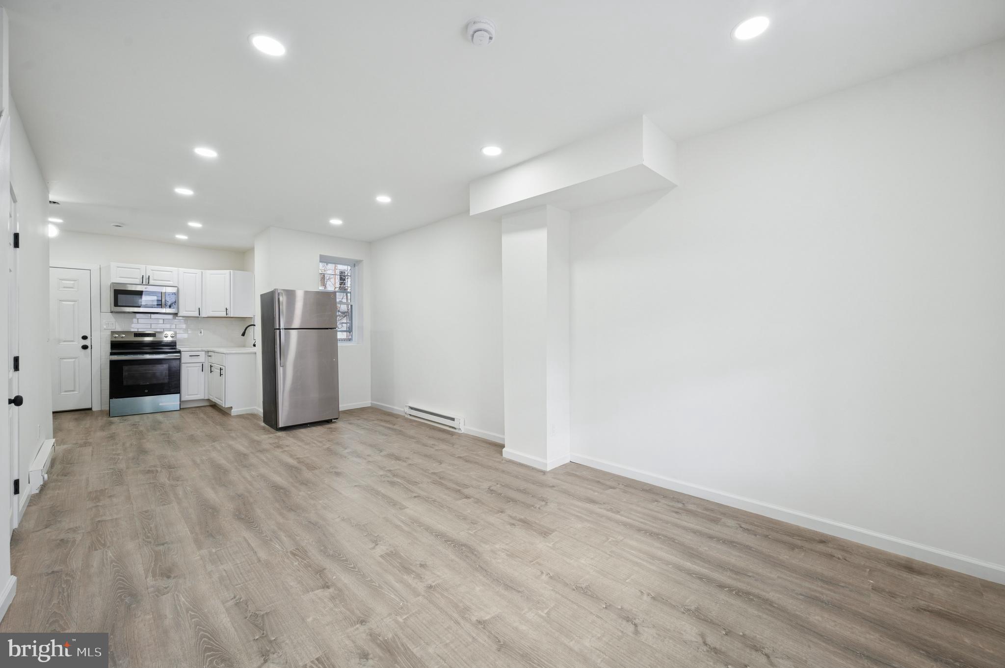 5929 Spring Street Philadelphia, PA 19139 - Photo 2 of 15 a view of kitchen with refrigerator and wooden floor