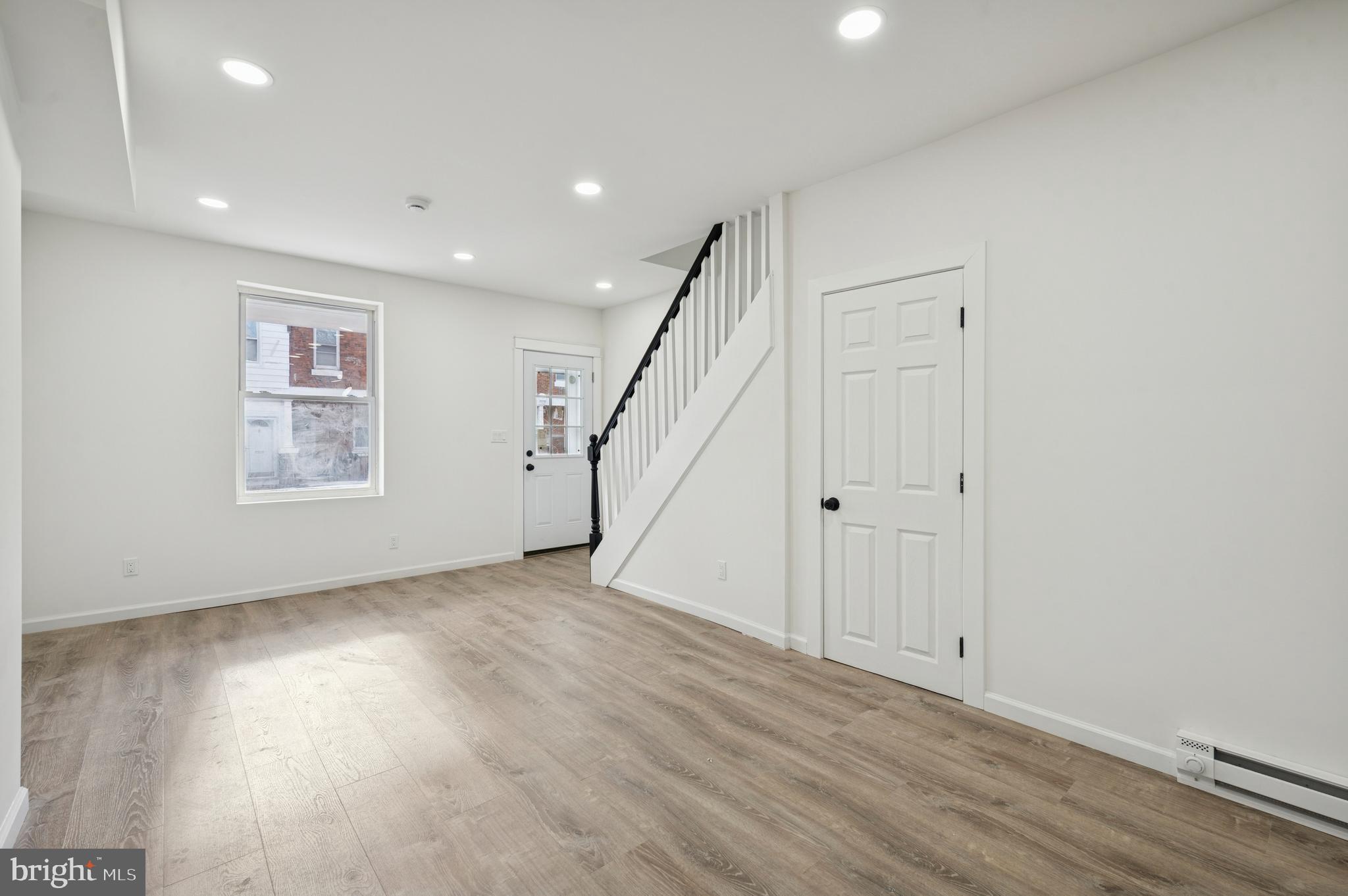 5929 Spring Street Philadelphia, PA 19139 - Photo 5 of 15 a view of an empty room with wooden floor and stairs