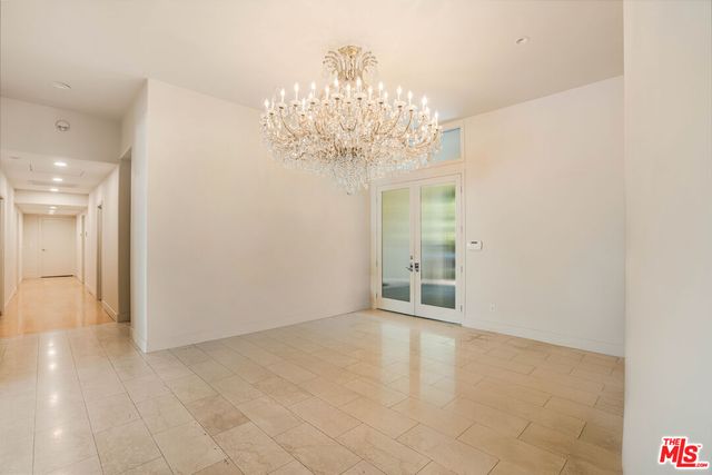 a large kitchen with stainless steel appliances granite countertop a lot of counter space and wooden floor