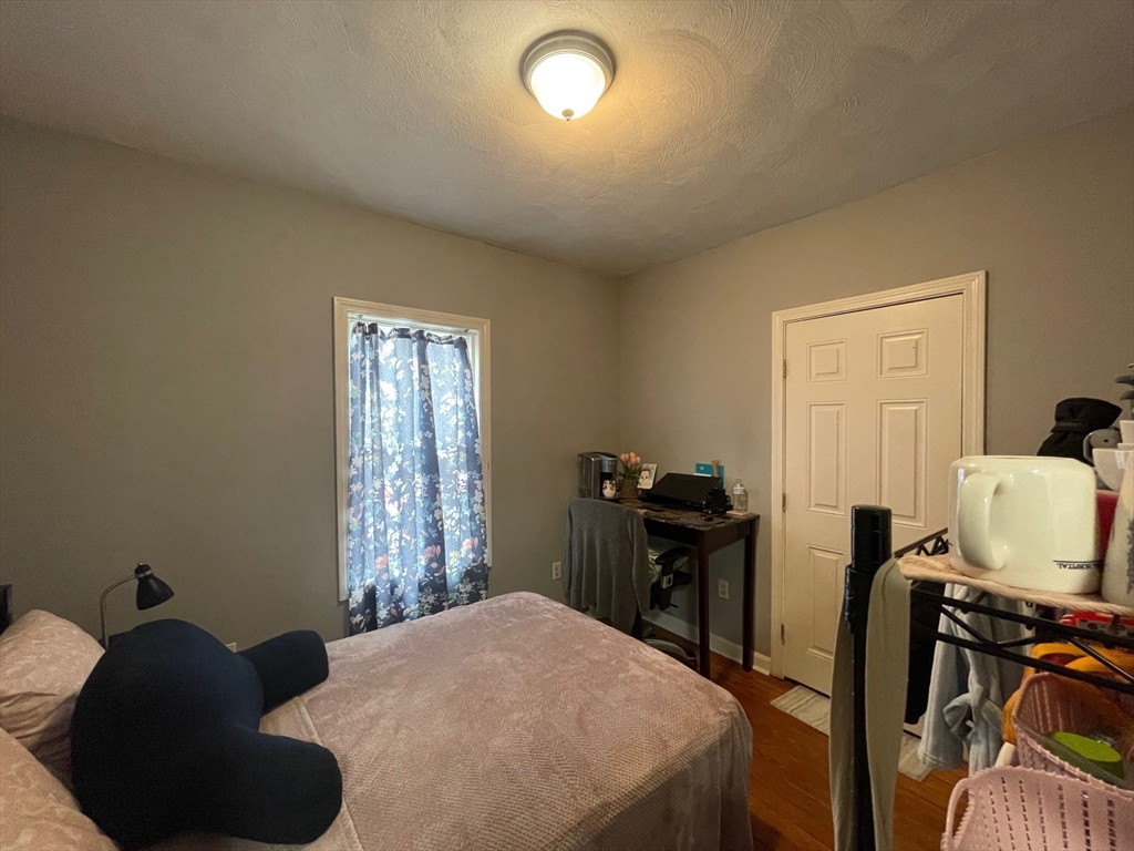 48 Derby Street, Unit 1 Somerville, MA 02145 - Photo 5 of 10 a bedroom with a bed and wooden floor