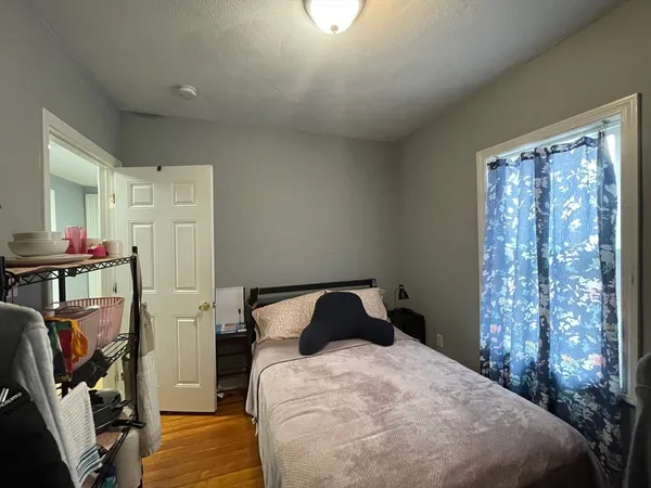 a bedroom with a bed closet and a window