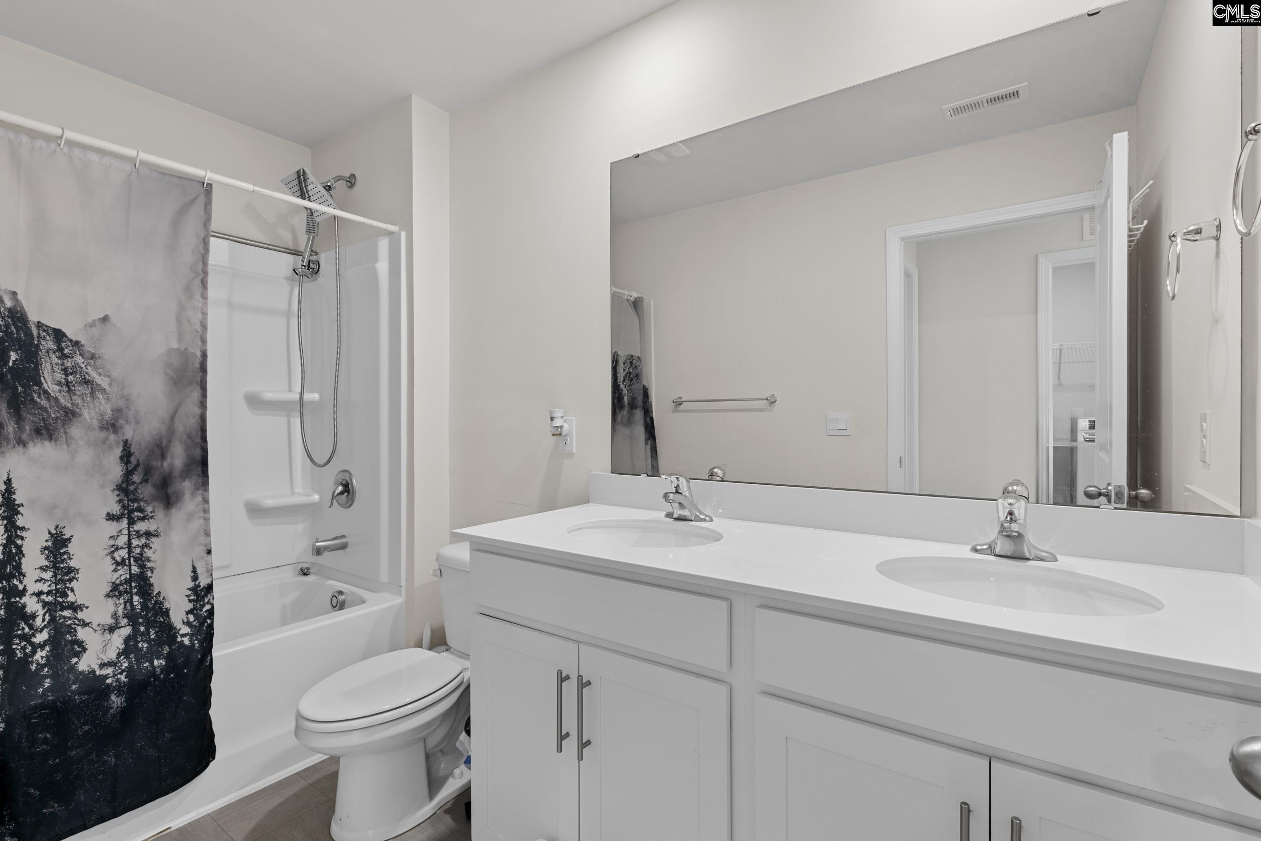 2097 Elmridge Road Columbia, SC 29209 - Photo 9 of 9 a bathroom with a sink toilet a shower and a mirror