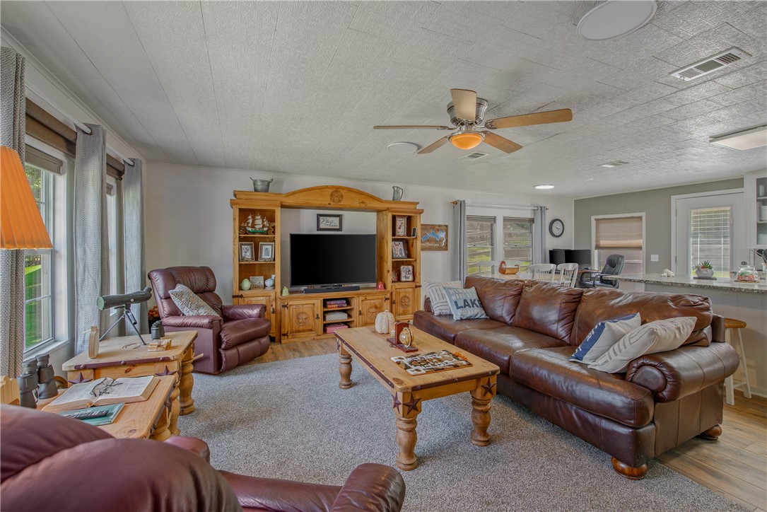 11001 Clyde Acord Road Franklin, TX 77856 - Photo 13 of 43 a living room with furniture a ceiling fan and a flat screen tv