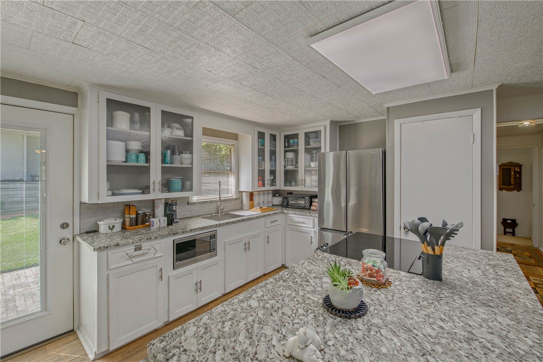 11001 Clyde Acord Road Franklin, TX 77856 - Photo 15 of 43 a kitchen with a sink stove and cabinets