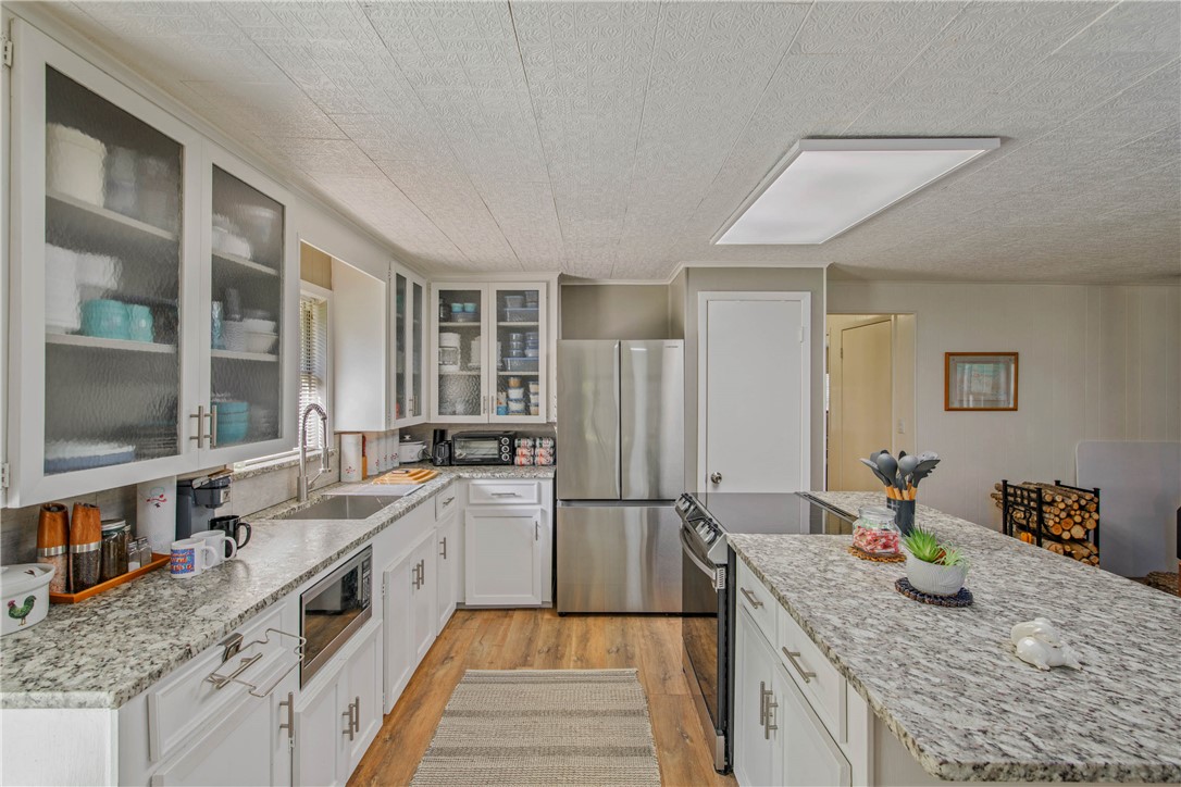 11001 Clyde Acord Road Franklin, TX 77856 - Photo 16 of 43 a kitchen with stainless steel appliances granite countertop a sink stove and refrigerator