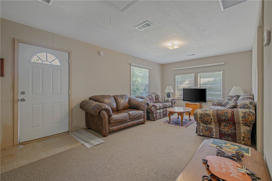 11001 Clyde Acord Road Franklin, TX 77856 - Photo 36 of 43 a living room with furniture a flat screen tv and a window