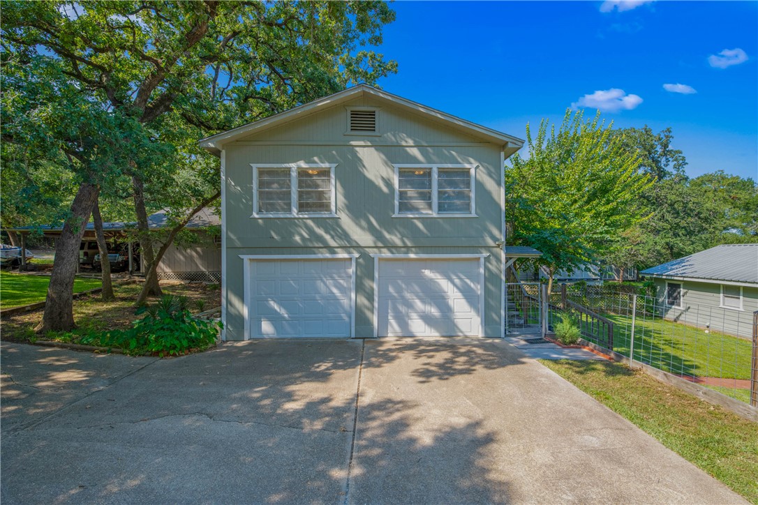 11001 Clyde Acord Road Franklin, TX 77856 - Photo 4 of 43 a front view of a house with a yard and garage