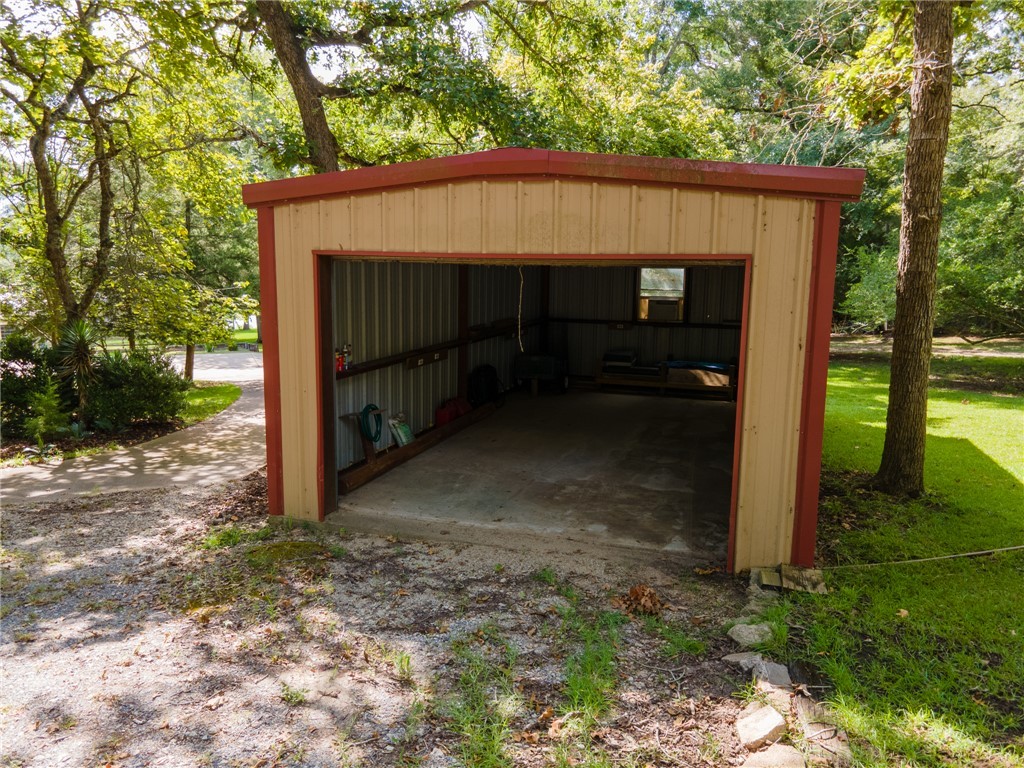 11001 Clyde Acord Road Franklin, TX 77856 - Photo 42 of 43 a view of a small house with a large tree and a yard