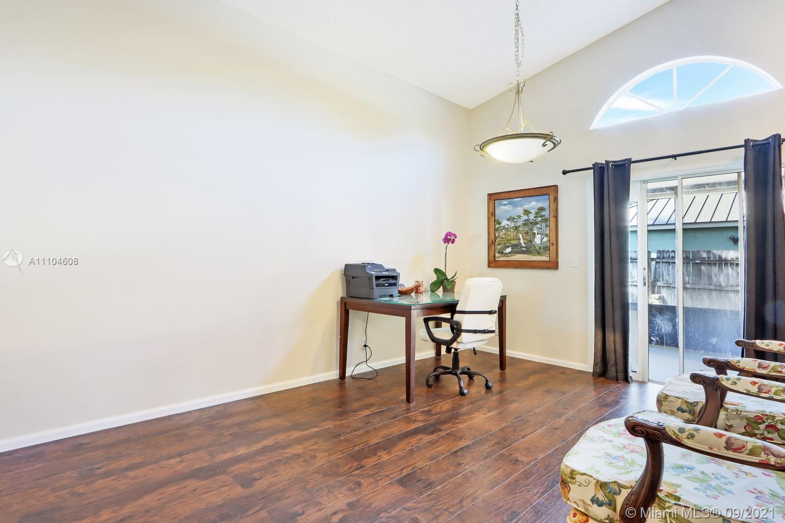 6247 Robinson Street Jupiter, FL 33458 - Photo 11 of 56 a workspace with furniture window and wooden floor