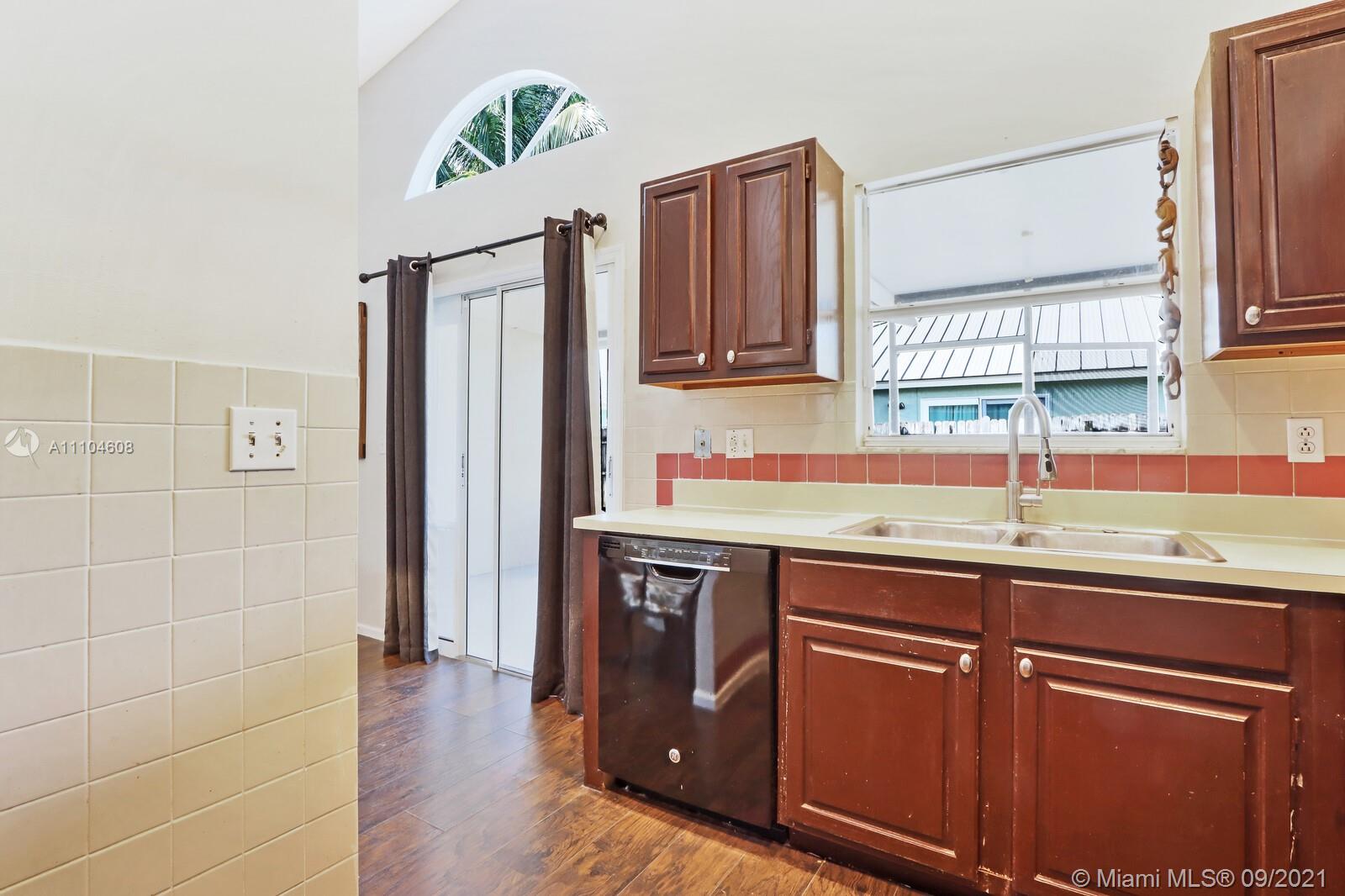 6247 Robinson Street Jupiter, FL 33458 - Photo 13 of 56 a kitchen with stainless steel appliances granite countertop a sink and a refrigerator
