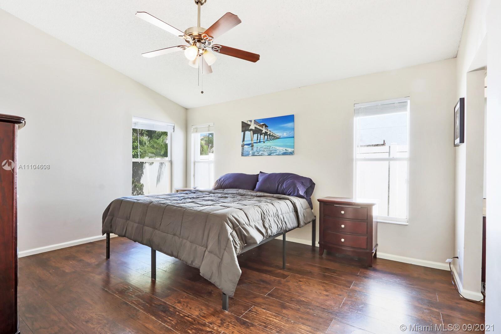 6247 Robinson Street Jupiter, FL 33458 - Photo 15 of 56 a bed room with a bed and a chandelier