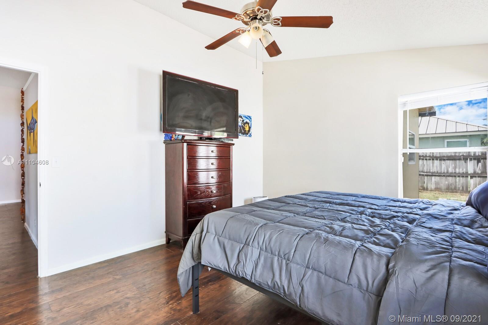 6247 Robinson Street Jupiter, FL 33458 - Photo 16 of 56 a bedroom with a bed and a flat screen tv