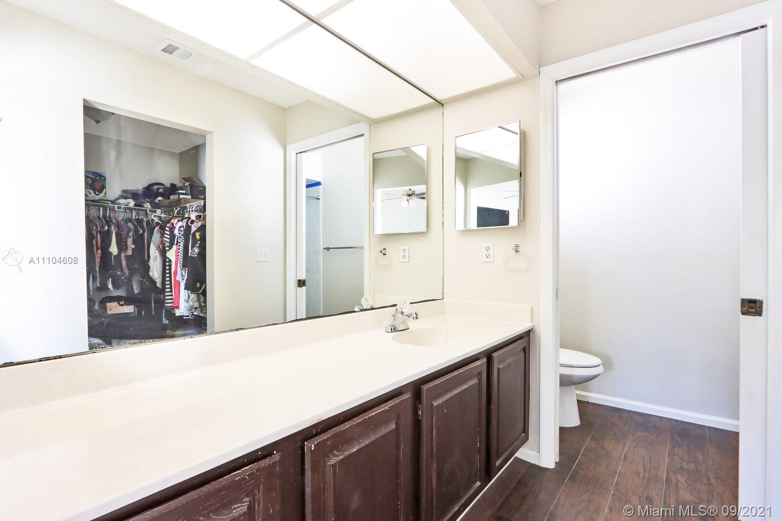 6247 Robinson Street Jupiter, FL 33458 - Photo 17 of 56 a bathroom with a double vanity sink and a mirror