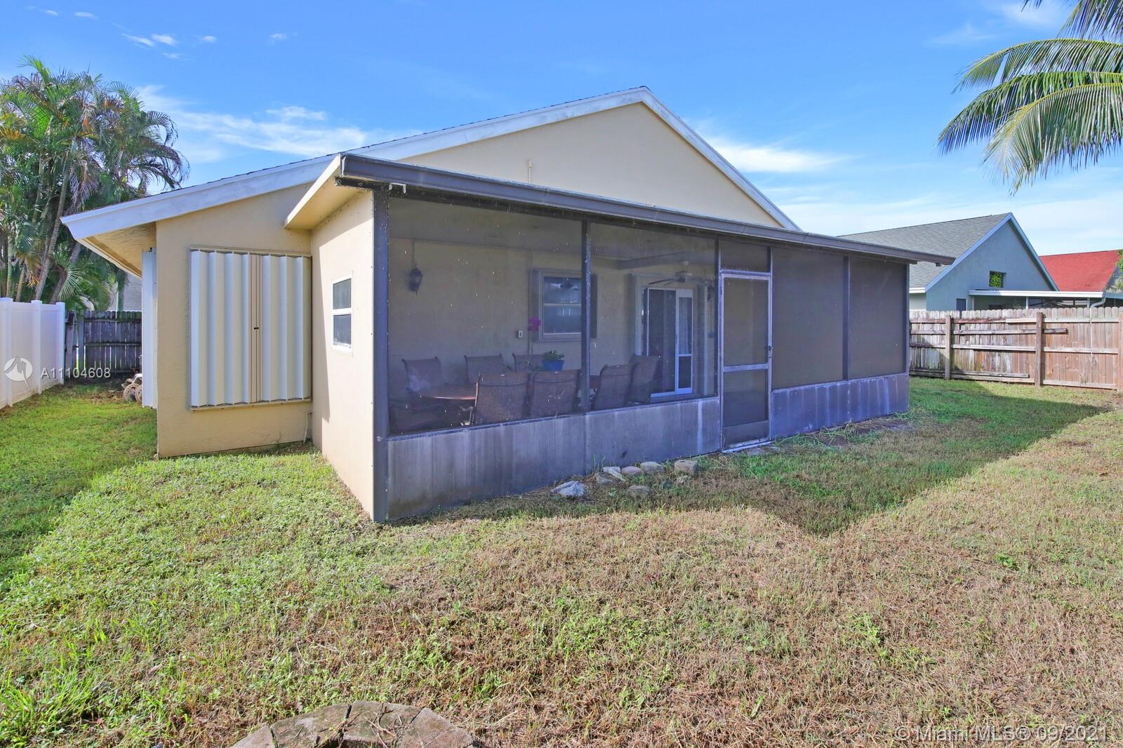6247 Robinson Street Jupiter, FL 33458 - Photo 25 of 56 a front view of a house with garden