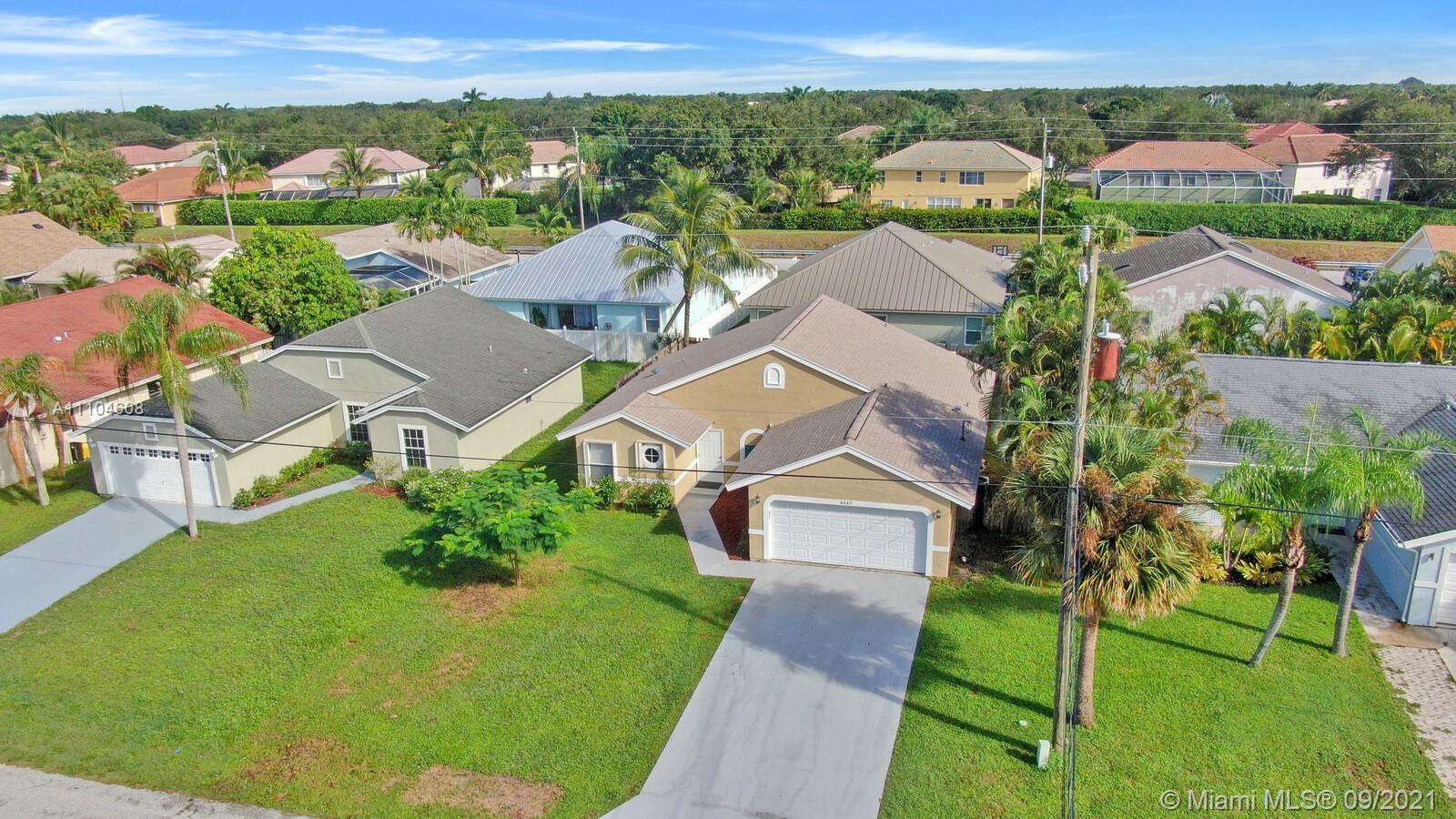 6247 Robinson Street Jupiter, FL 33458 - Photo 28 of 56 an aerial view of residential houses with outdoor space and trees