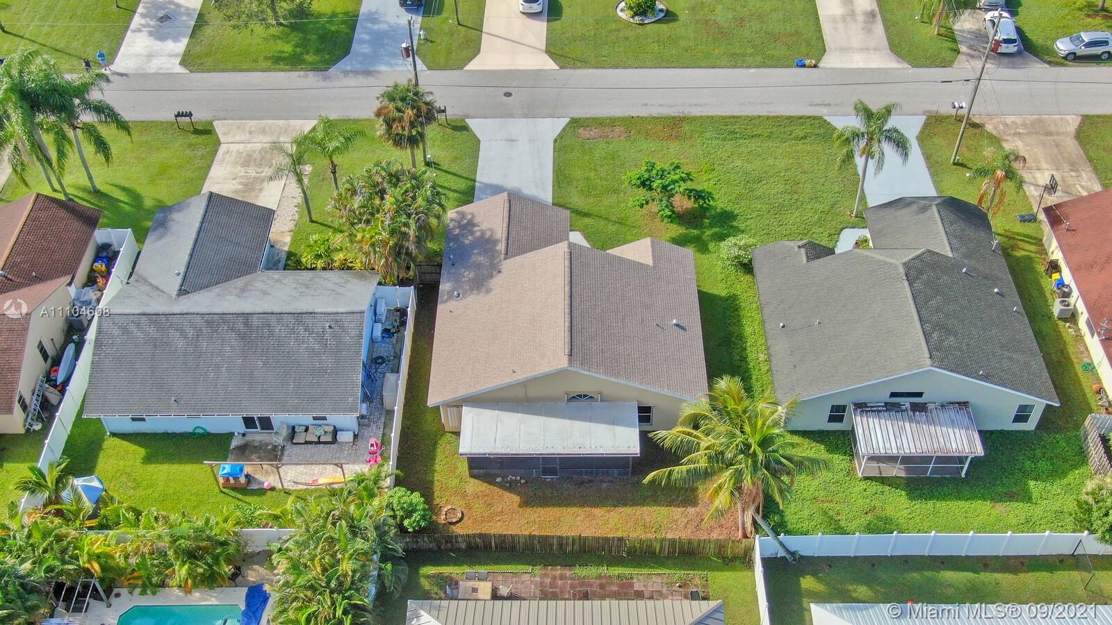 6247 Robinson Street Jupiter, FL 33458 - Photo 30 of 56 an aerial view of a house with garden space and a yard