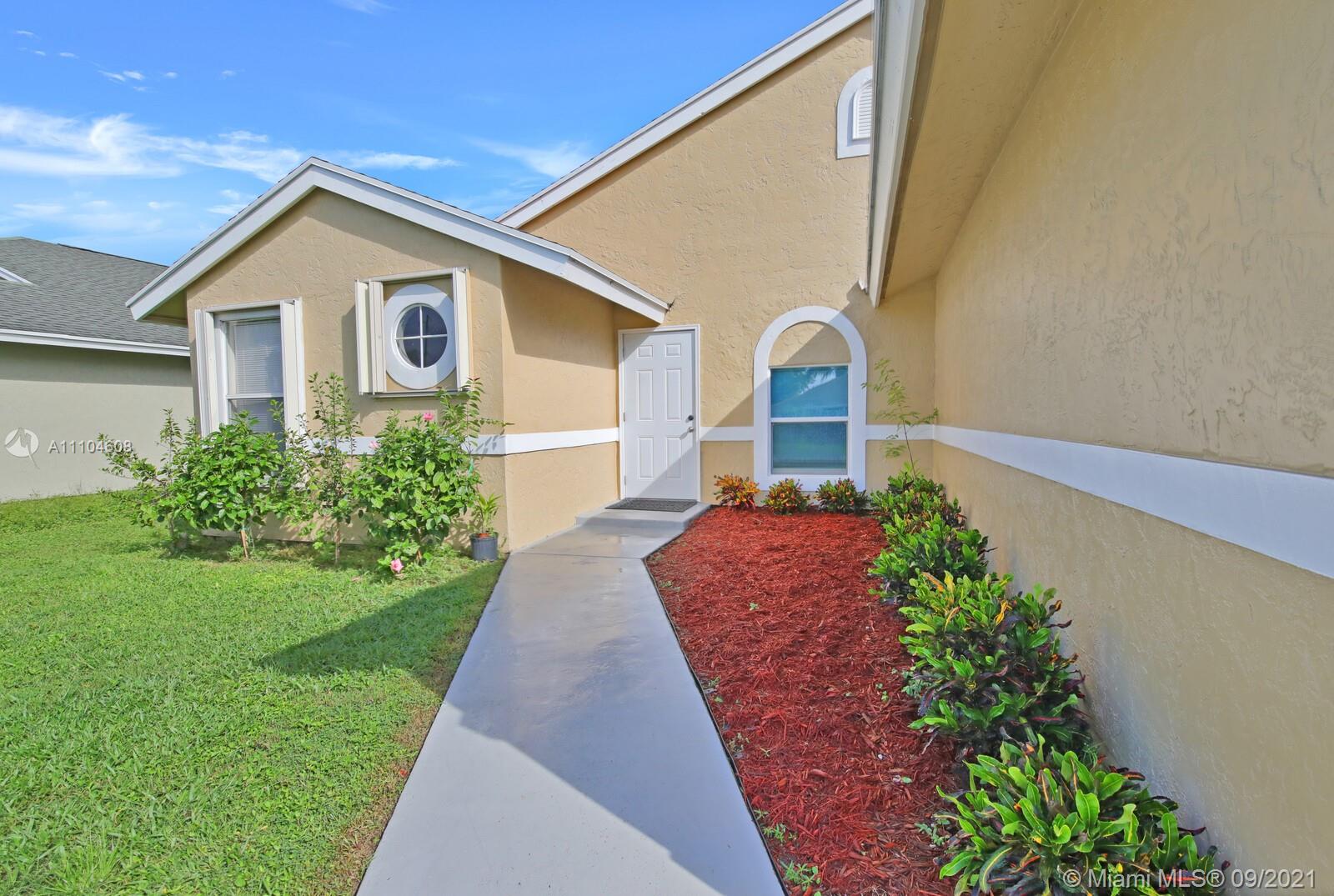 6247 Robinson Street Jupiter, FL 33458 - Photo 4 of 56 a front view of a house with a yard