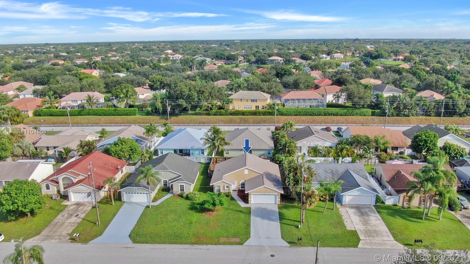 6247 Robinson Street Jupiter, FL 33458 - Photo 33 of 56 an aerial view of a house with a garden and lake view