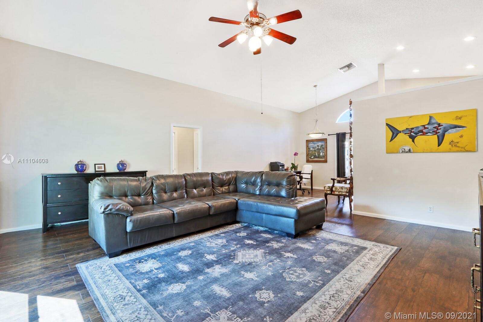 6247 Robinson Street Jupiter, FL 33458 - Photo 6 of 56 a living room with furniture and wooden floor