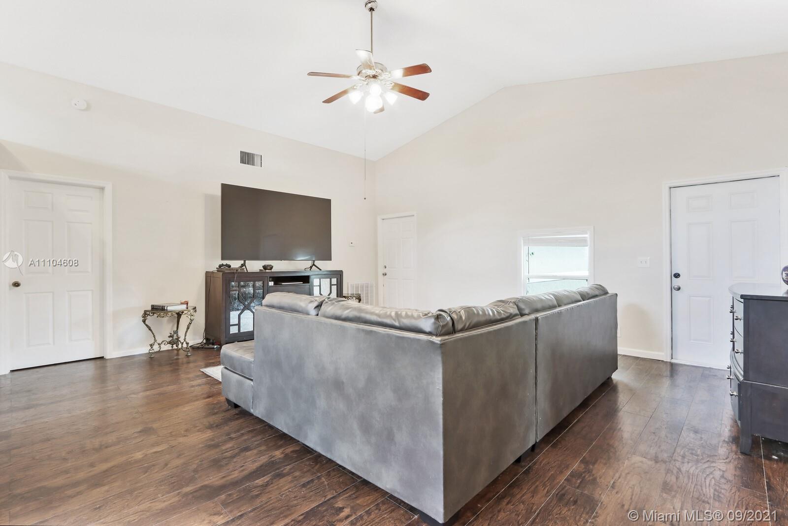 6247 Robinson Street Jupiter, FL 33458 - Photo 7 of 56 a living room with furniture and a flat screen tv