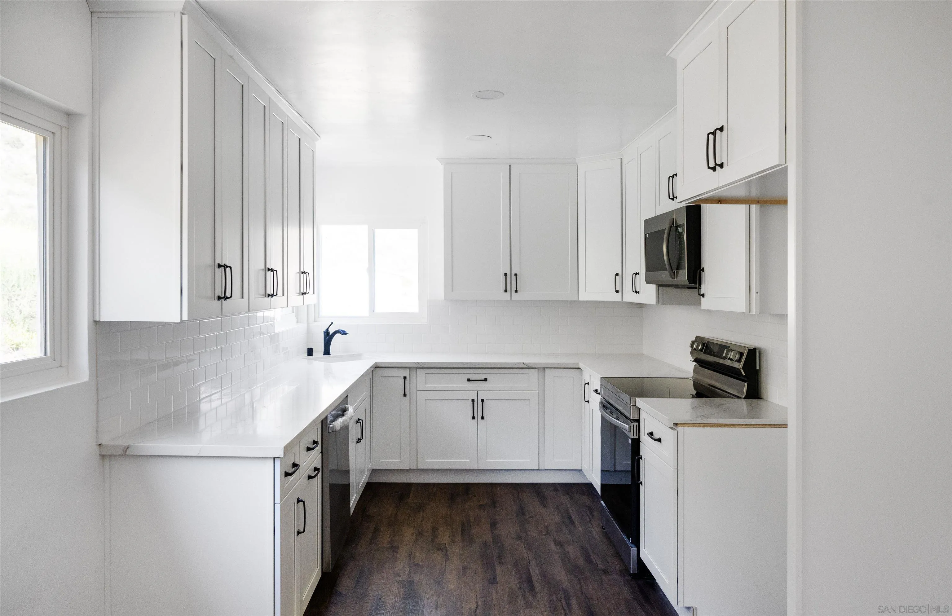 13504 Willow Road Lakeside, CA 92040 - Photo 4 of 9 a kitchen with a sink cabinets stainless steel appliances and a window