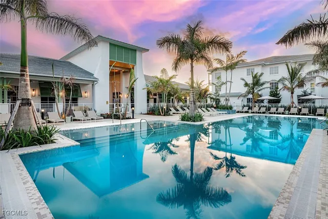 a swimming pool with outdoor seating and yard