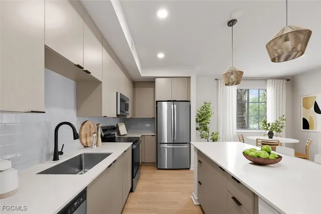 a kitchen with stainless steel appliances a dining table and chairs in it
