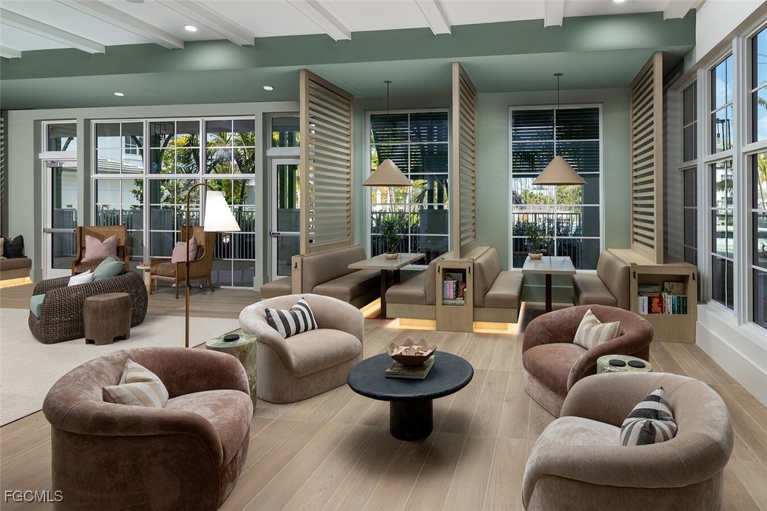 6026 Whitaker Road, Unit A1 Naples, FL 34112 - Photo 6 of 23 a living room with furniture and a large window