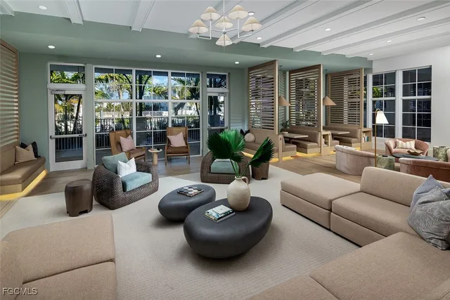 a living room with furniture and large windows