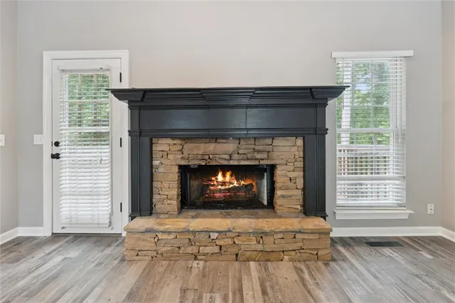 a living room with a fireplace with wooden floor