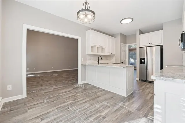 a view of a kitchen with wooden floor