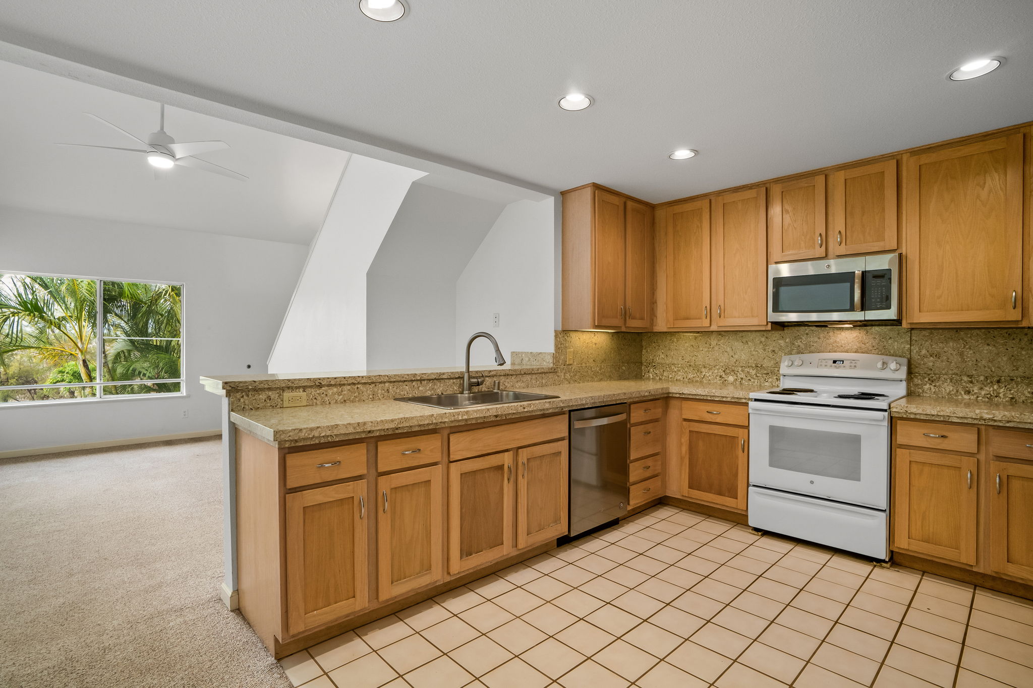 1831 Poipu Road, Unit 324 Koloa, HI 96756 - Photo 2 of 10 a kitchen with a sink stove and microwave
