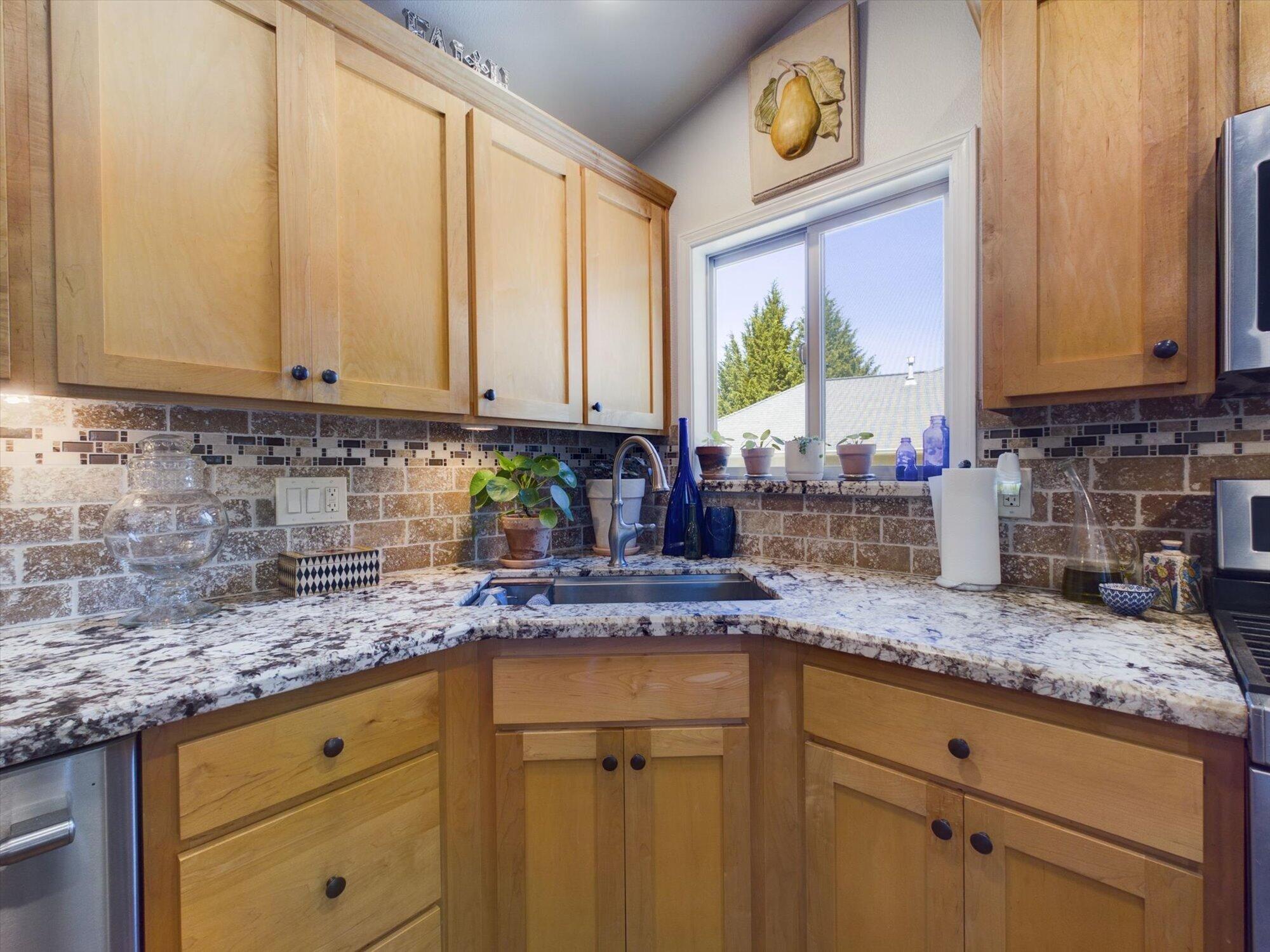 178 Grayland Heights Road Rio Dell, CA 95562 - Photo 17 of 52 a kitchen with granite countertop a sink a stove cabinets and a counter top space