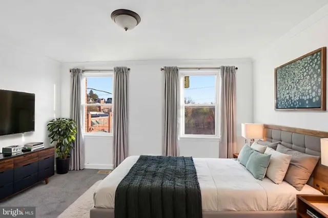 a bedroom with a bed and a flat screen tv