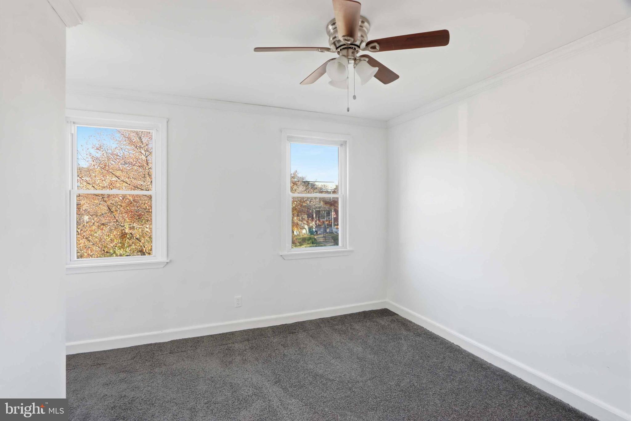 3547 Benzinger Road Baltimore, MD 21229 - Photo 16 of 24 an empty room with a window and a fan