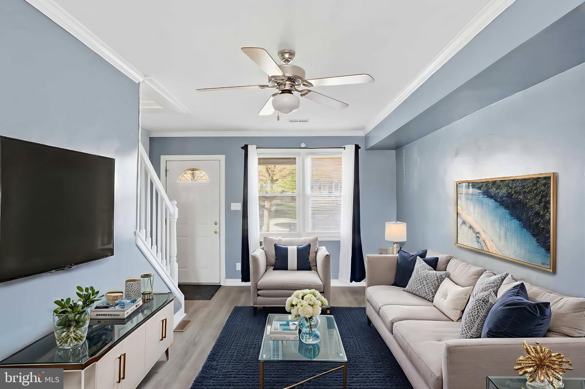 3547 Benzinger Road Baltimore, MD 21229 - Photo 4 of 24 a living room with furniture a flat screen tv and a large window