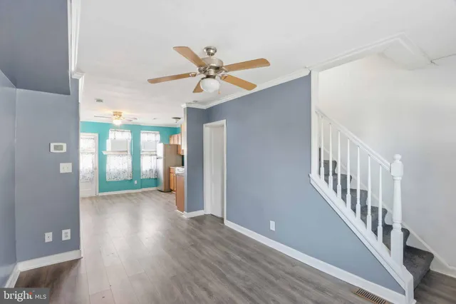 a view of a hallway with wooden floor and entryway