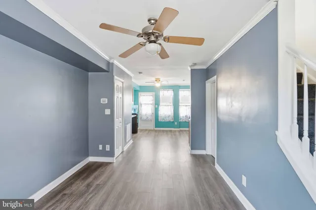 a view of hallway with wooden floor