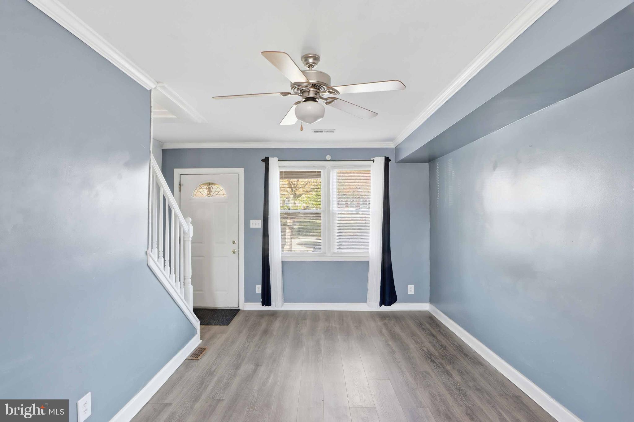 3547 Benzinger Road Baltimore, MD 21229 - Photo 7 of 24 wooden floor in an empty room with a window