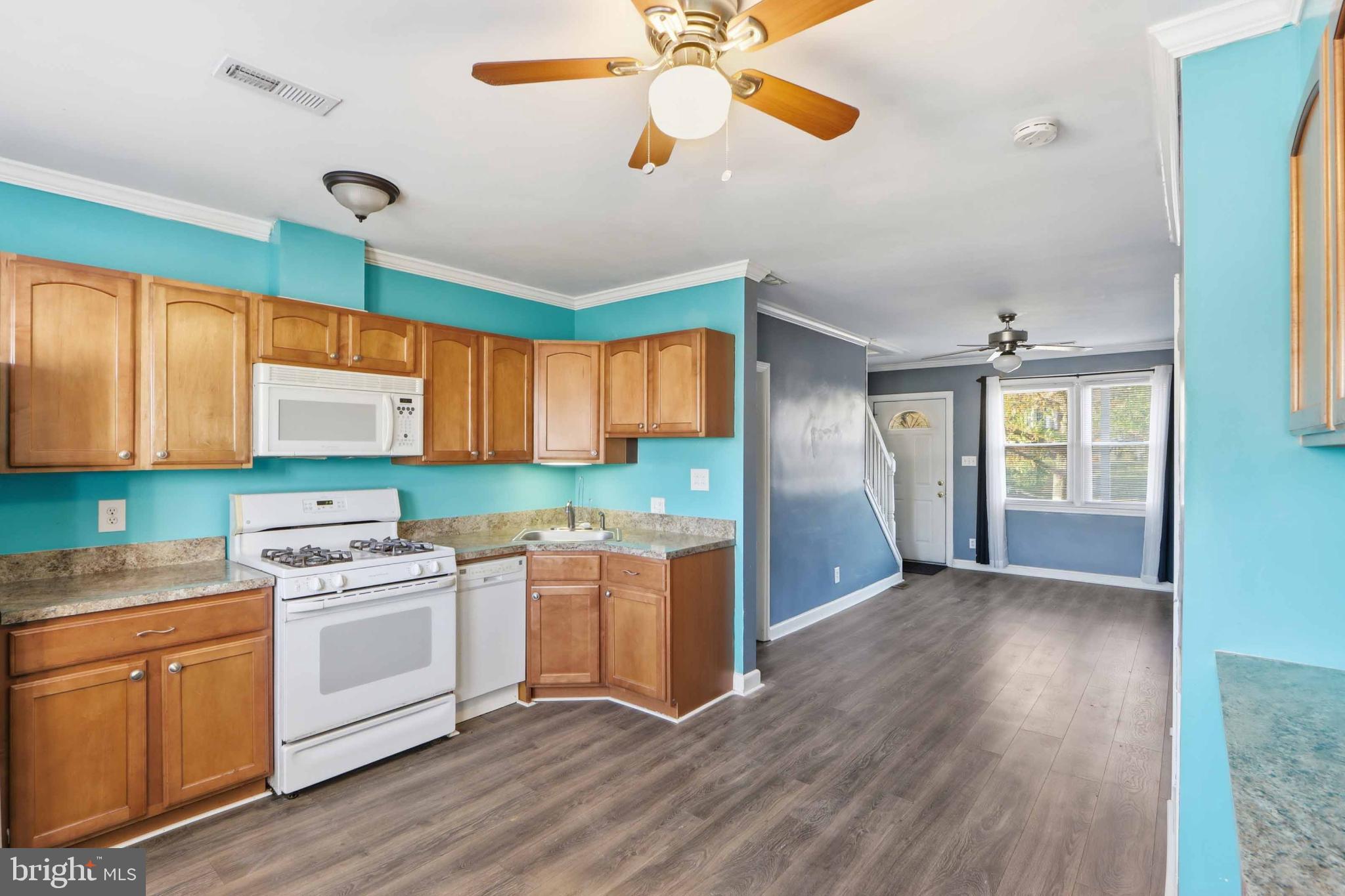3547 Benzinger Road Baltimore, MD 21229 - Photo 10 of 24 a kitchen with stainless steel appliances granite countertop a stove a sink dishwasher and a refrigerator with wooden floor