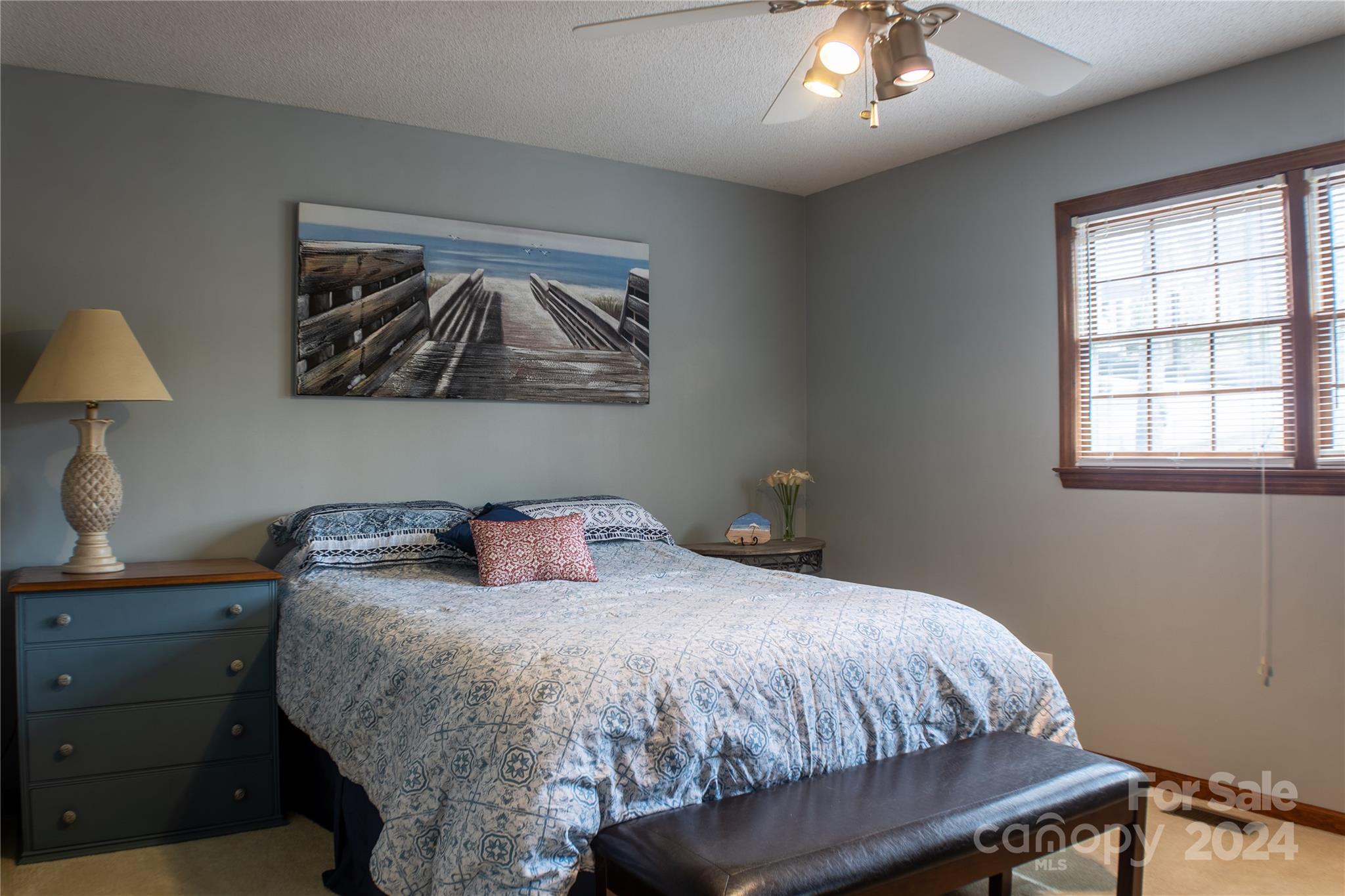 281 Jubal Reeves Circle, Unit 1465 Mount Gilead, NC 27306 - Photo 11 of 17 a bedroom with a bed and a lamp on dresser