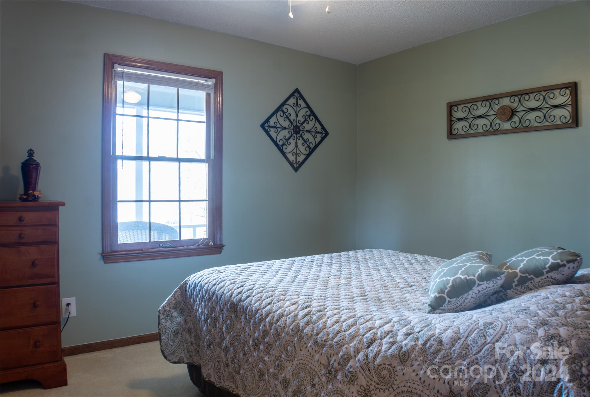 281 Jubal Reeves Circle, Unit 1465 Mount Gilead, NC 27306 - Photo 14 of 17 a bedroom with a bed a window and wall painting