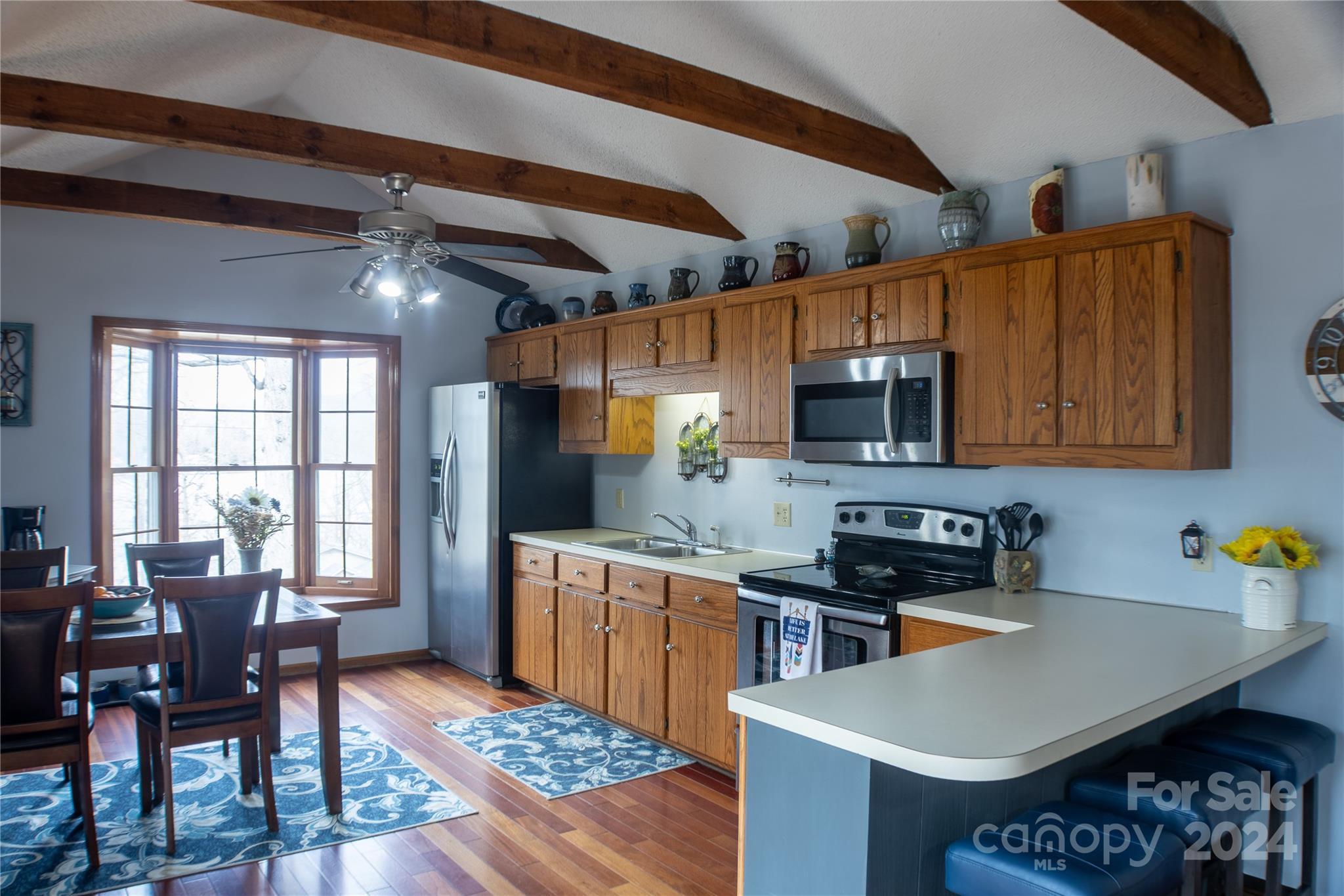 281 Jubal Reeves Circle, Unit 1465 Mount Gilead, NC 27306 - Photo 8 of 17 a kitchen with stainless steel appliances a stove a sink dishwasher and a refrigerator