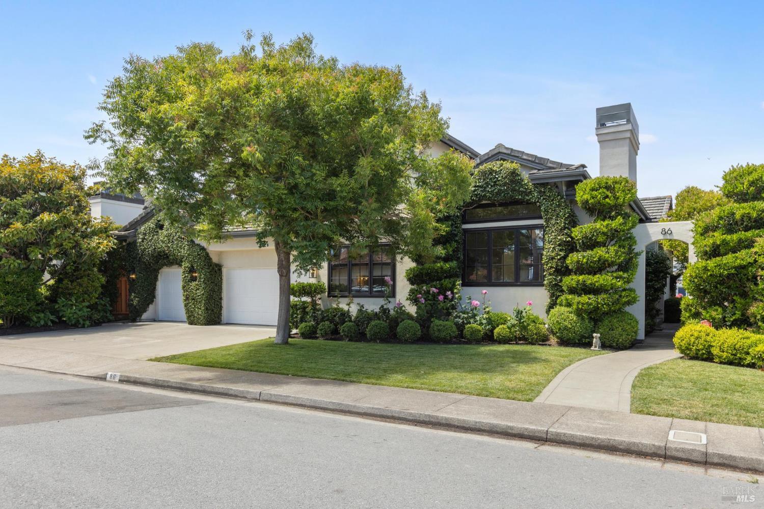 a house that has a tree in front of it