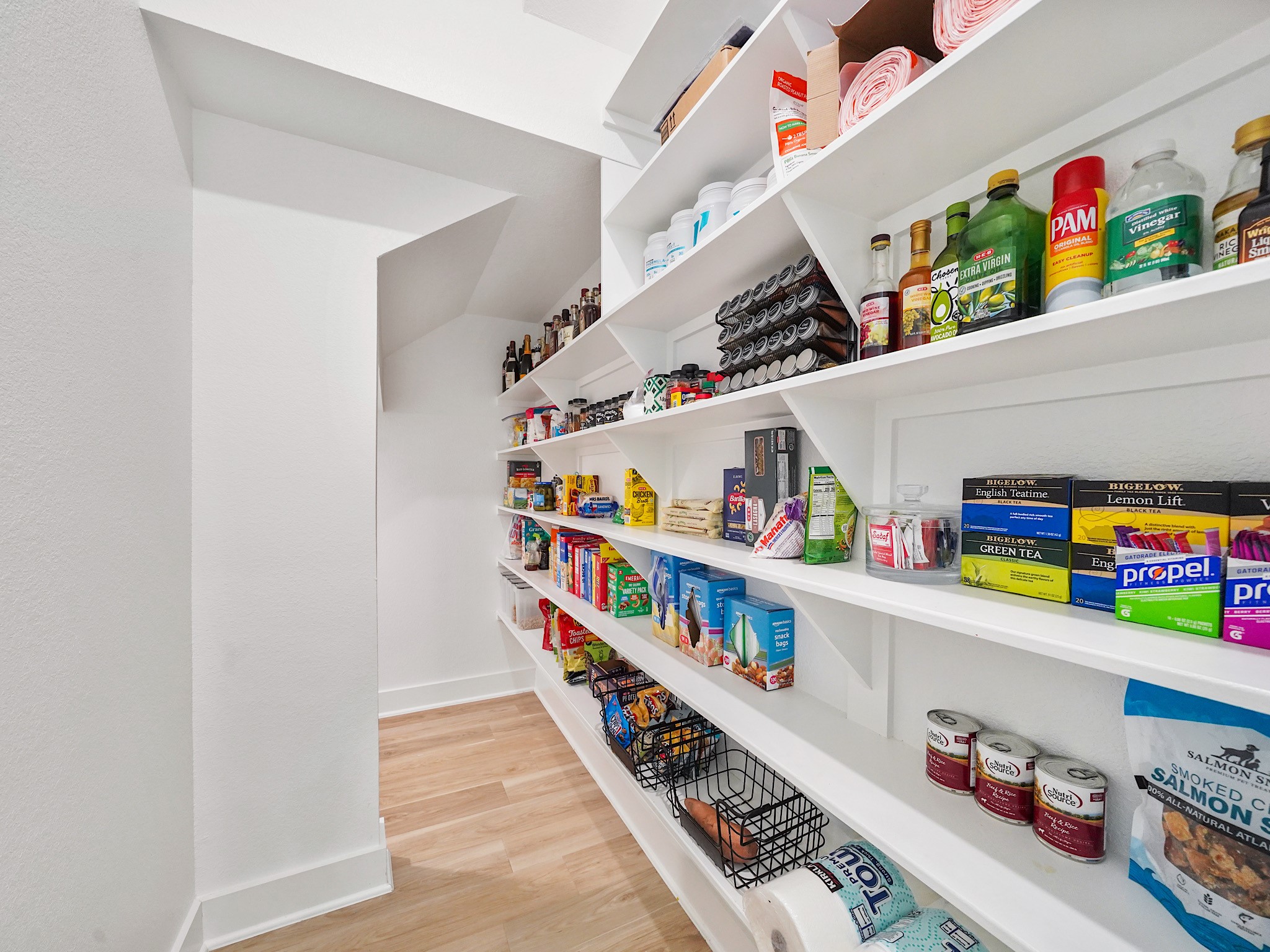 5802 Emerald Ranch Lane Fulshear, TX 77441 - Photo 13 of 45 This impressive walk-in pantry provides exceptional storage with open shelving, offering space for everything from small appliances to everyday essentials while keeping the kitchen beautifully organized.