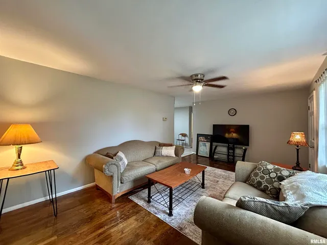 a living room with furniture and a lamp