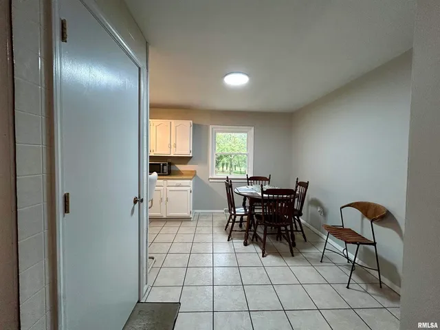 a view of a dining room with furniture and chandelier