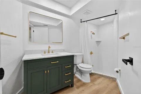 a bathroom with a shower sink and mirror
